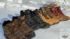 All four budget hiking boots lined up in the snow next to eaohother