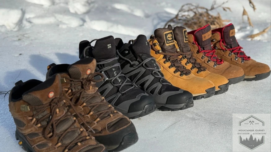 All four budget hiking boots lined up in the snow next to eaohother