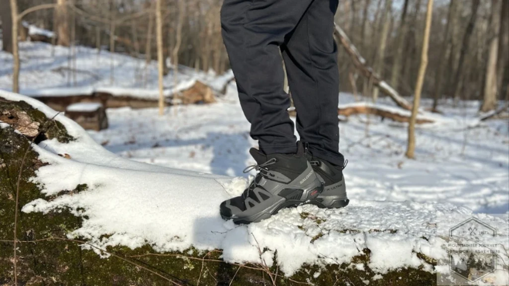 Personally testing the Salomon X Ultra 4 Mid GTX on a log showcasing our testing process