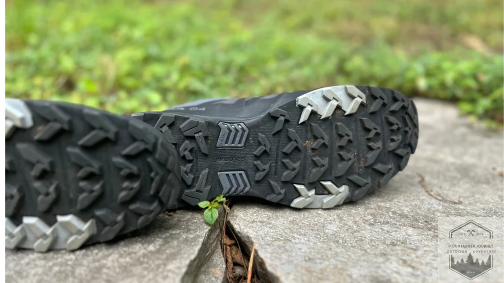 Checking out the Outsole traction lugs on each hiking boot on a wall