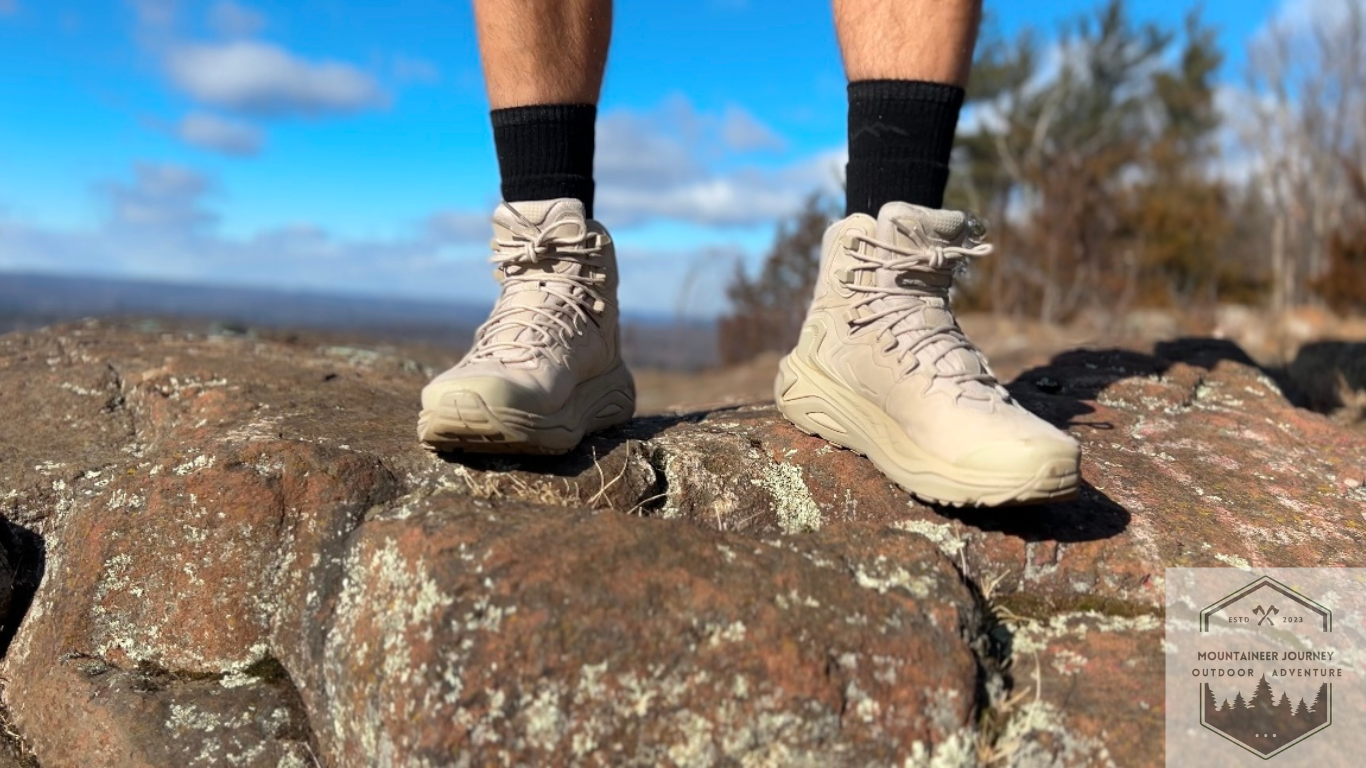 Hoka kaha 3 at top of rock with overlying blue sky