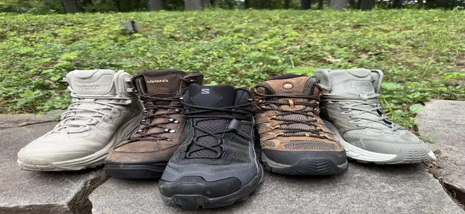 All the top lightweight hiking boots lined up on a wall