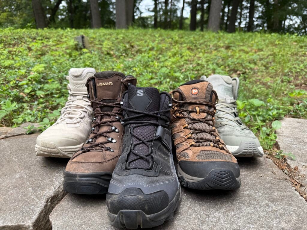 5 Different hiking boots on a wall. Showing the different types of materials and makeup of each