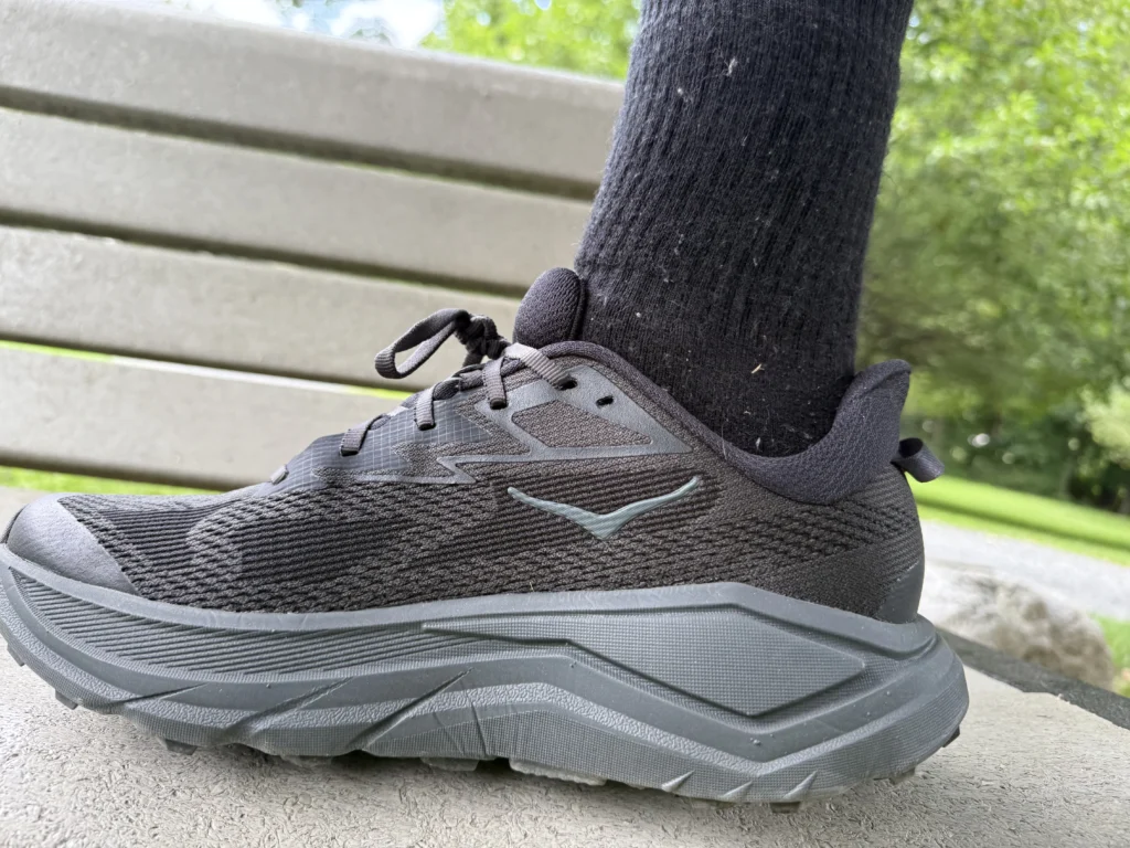 Highlighting the stack height of the Hoka Challenger 8 on a bench