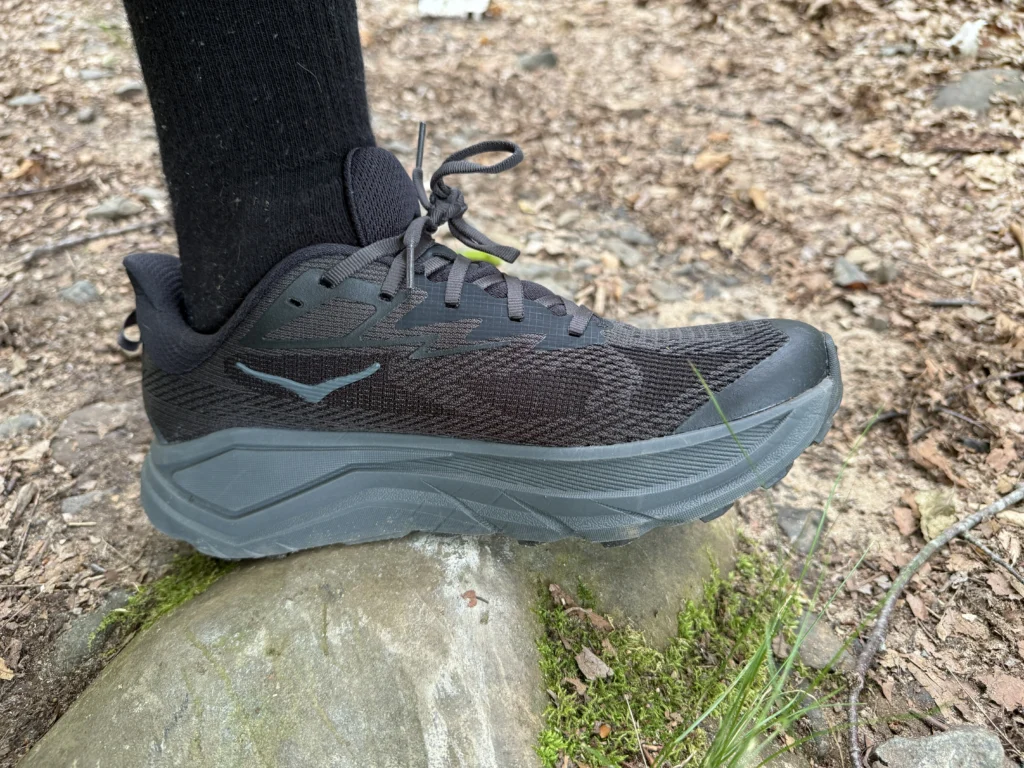 standing on a rock with the hoka challenger 8