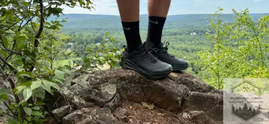 Standing at the top of a mountain summit with Altra Ultra Olympus 6