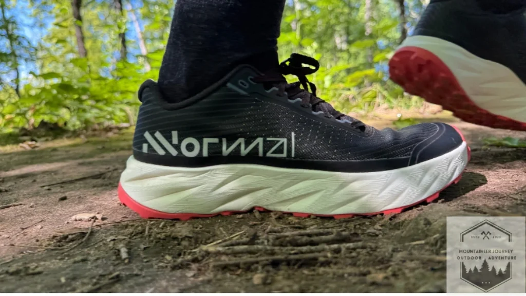 side view of the NNormal Kjerag 2 revealing the rockered sole while stepping in the dirt