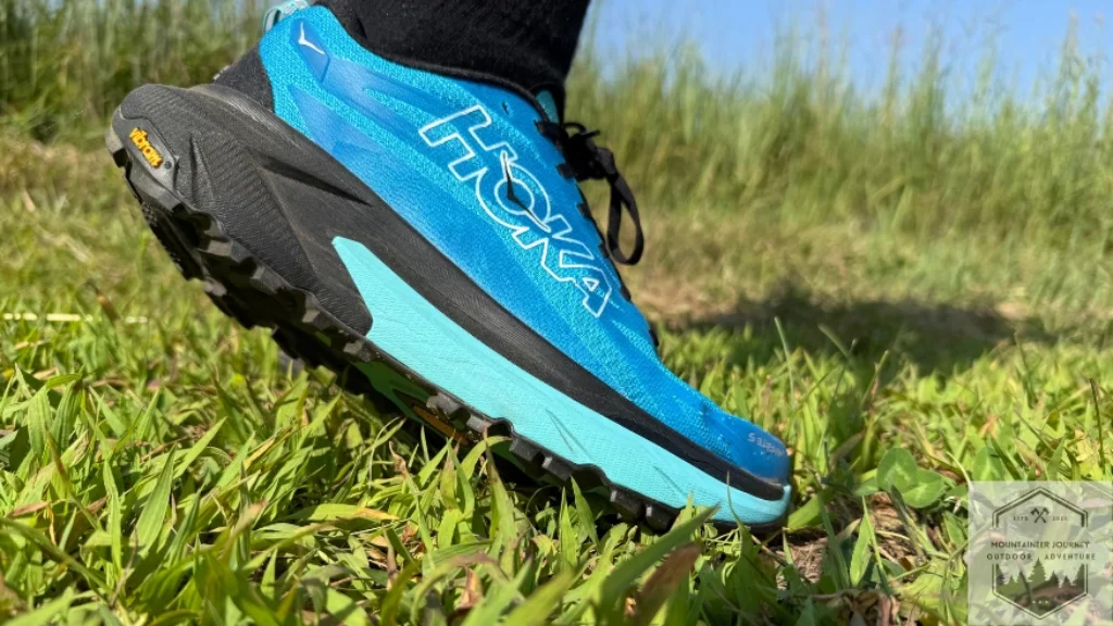 Showing massive stack height of Hoka Mafate 5 in grass