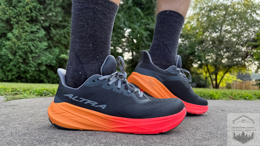 Altra Experience Flow 2 on asphalt testing. Featuring sides of shoe, with left one flexed up