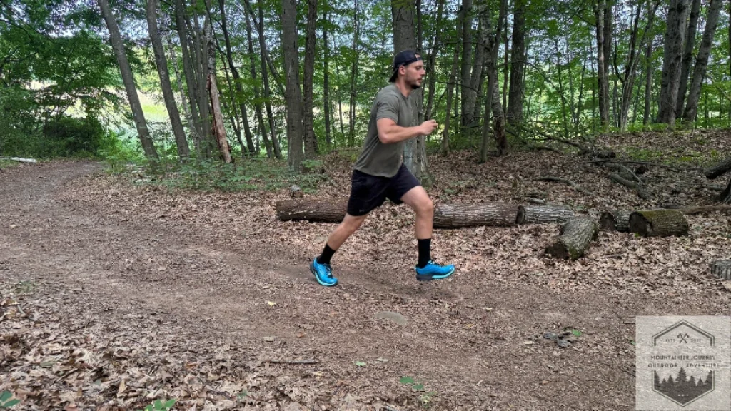 side view of shoes running in woods