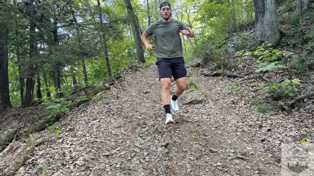 Norda 001 Vibram Megagrip outsole engaging reversed heel braking lugs on packed dirt, providing secure traction during descent