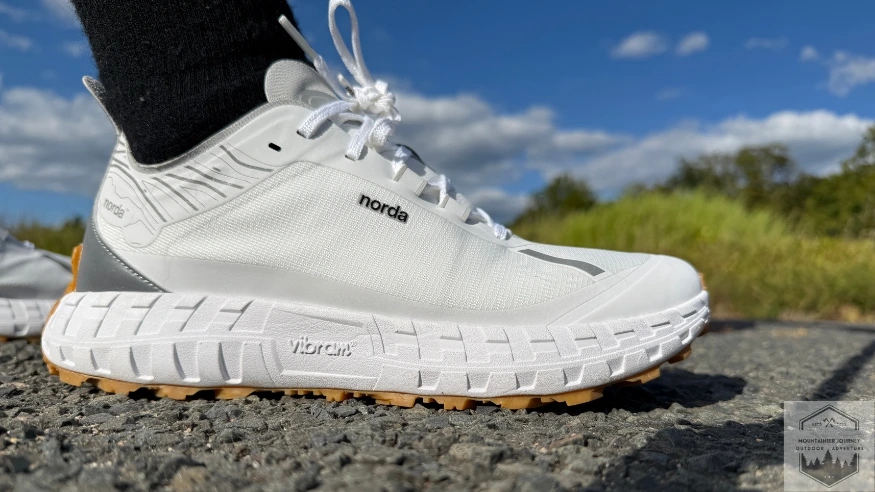 View of the Norda 001 on gravel with blue sky in back
