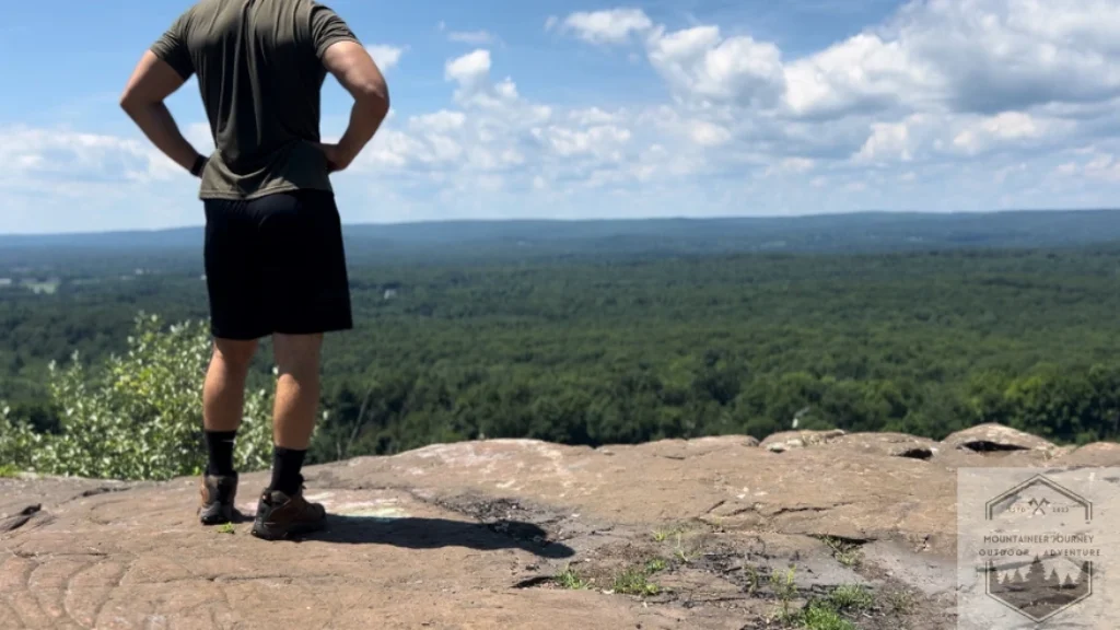 Standing at the top of the summit wearing the Moab 3