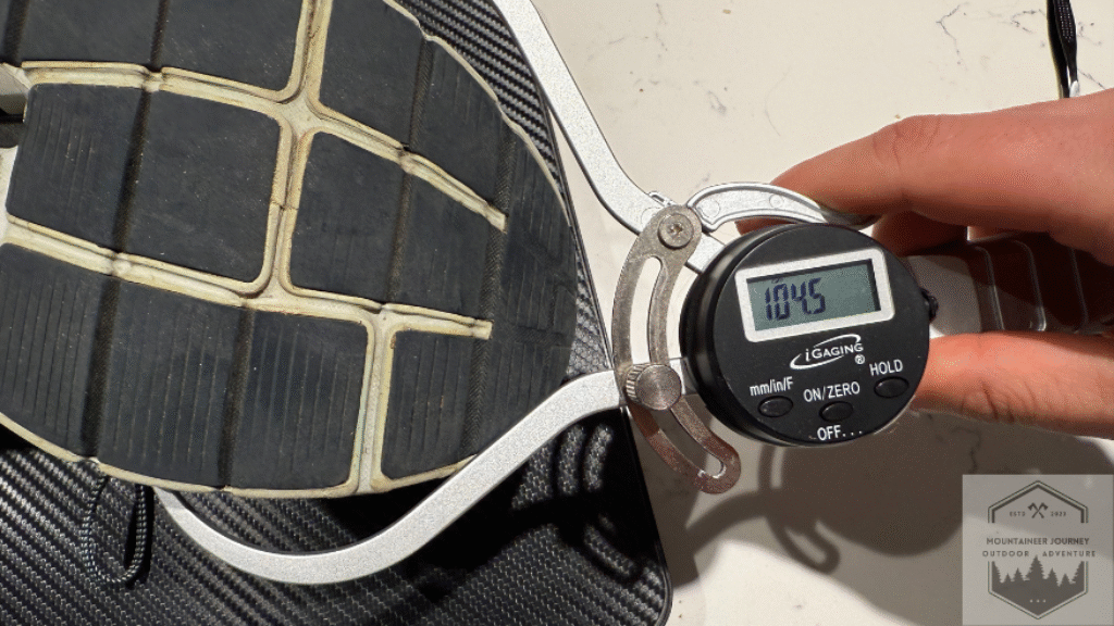 Measuring the On Cloud 6 forefoot width at 104 mm using a digital caliper to provide objective data on the shoe's midfoot volume and toe box space.