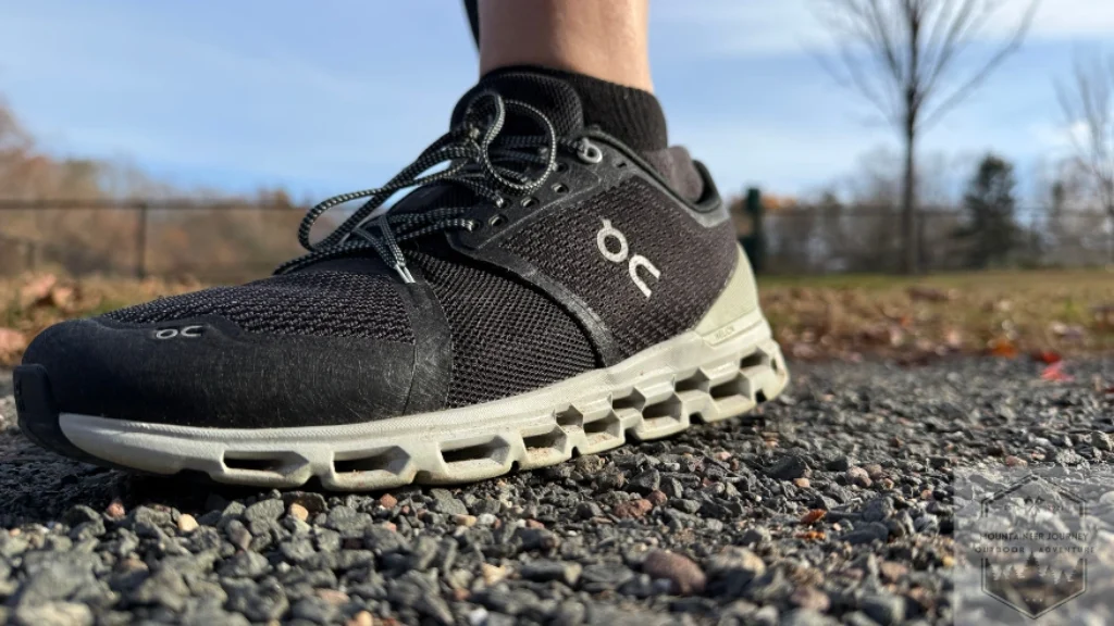 Full front view of the On Cloud 6 on a gravel path, highlighting the breathable engineered mesh upper and the signature speed lacing system for a secure, adjustable fit.