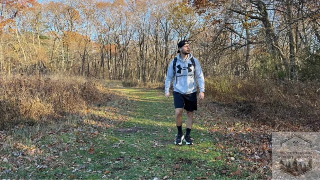 Testing the Hoka Bondi 9 on a light dirt trail to demonstrate its versatility as a max-cushion walking shoe for both urban pavement and park paths.