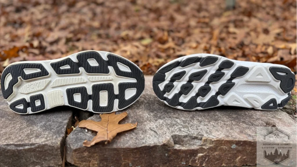 The Hoka Bondi 9 outsole on the left facing the outsole of the Clifton 9 on the right noting the differences in the tread of both shoes.