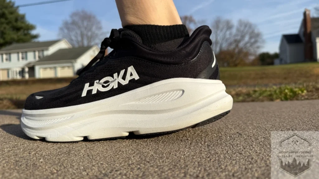 Side view of the Hoka Bondi 9 midsole highlighting the massive stack of plush compression-molded EVA foam for maximum shock absorption on hard surfaces.