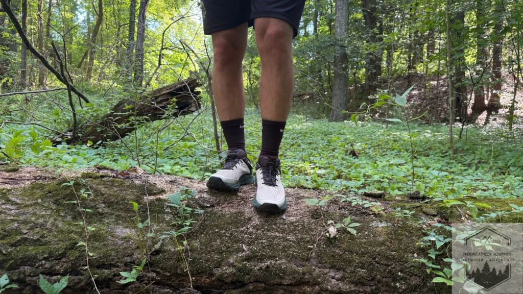 Standing on a log with the Merrell Nova 4 during testing