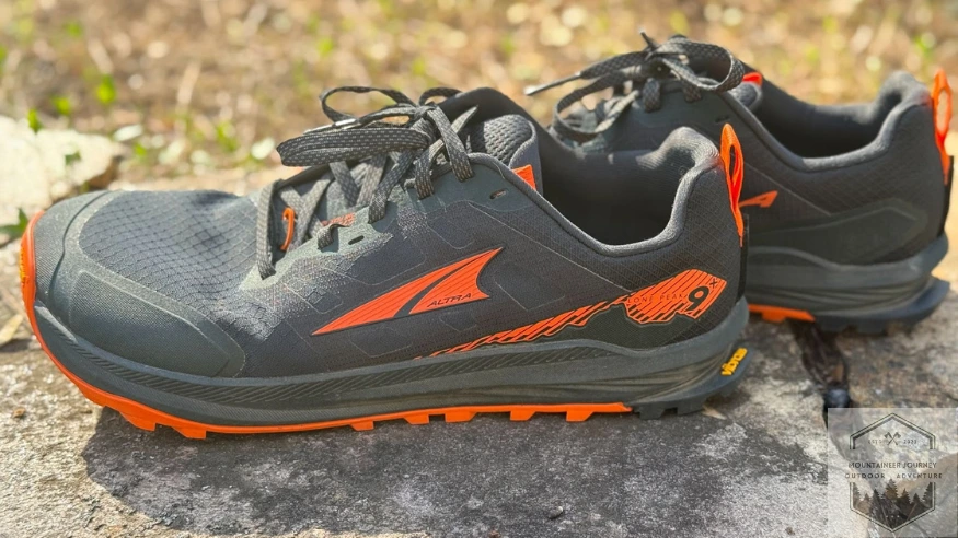 Side profile of Altra Lone Peak 9 resting on wall, displaying the flat Zero Drop geometry designed to promote a natural low-impact forefoot strike