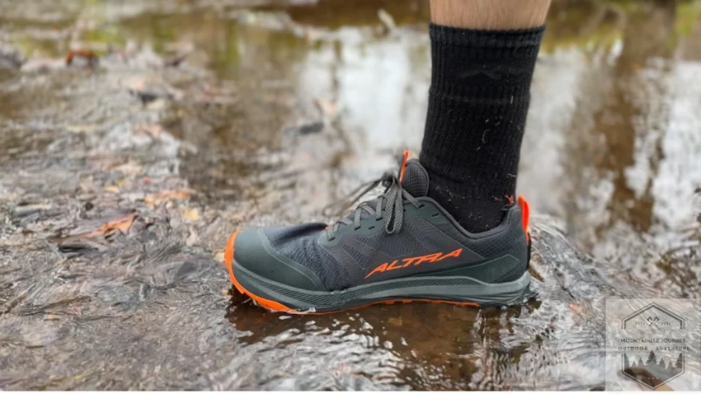 Standing in river with lone Peak 9+