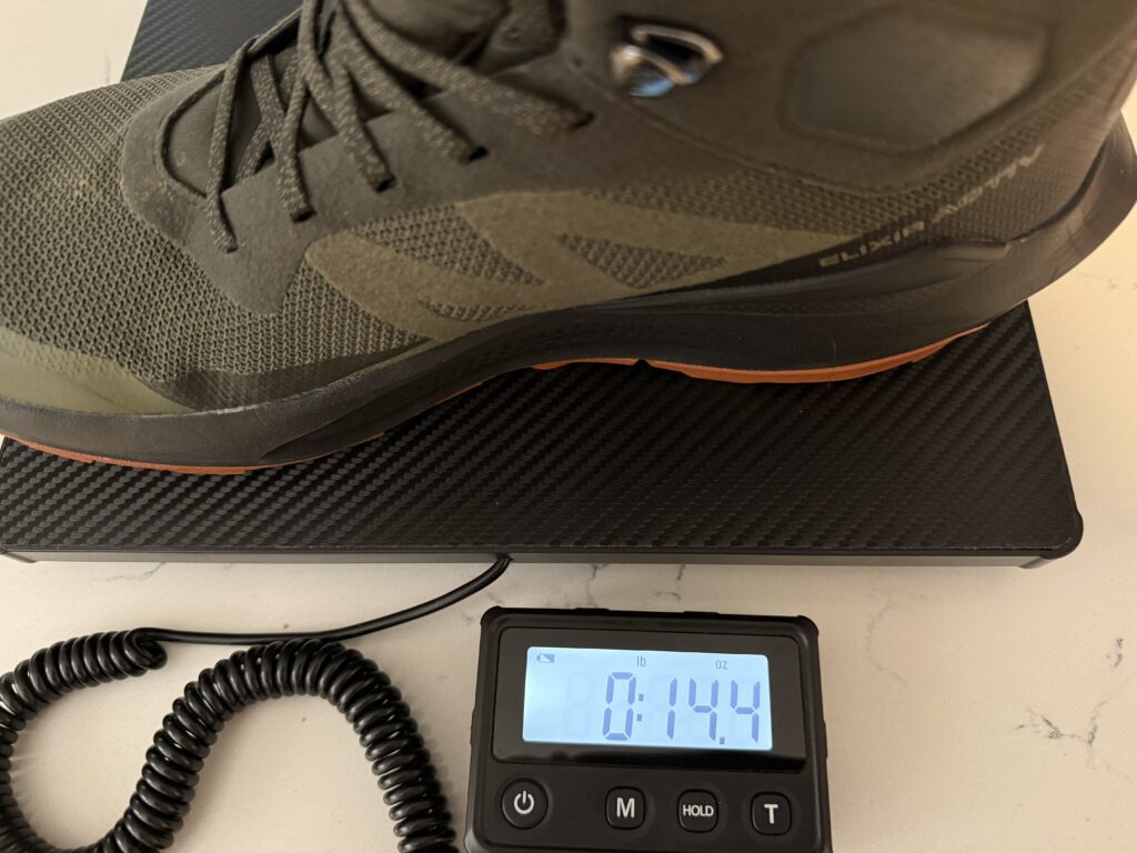 Salomon Elixir Activ on our scale weighing 14 ounces per boot